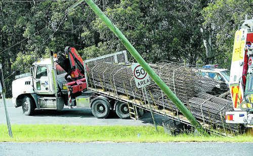 This single vehicle truck accident brought down live powerlines over the Pacific Highway at Woolgoolga yesterday. This single vehicle truck accident brought down live powerlines over the Pacific Highway at Woolgoolga yesterday.
